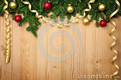 Christmas background with firtree, baubles and ribbons on wood Stock Photo