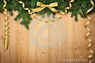 Christmas background with firtree, bow and ribbons on wood Stock Photo