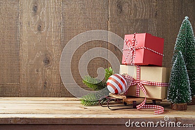 Christmas background with gift boxes and ornament on sledges on Stock Photo