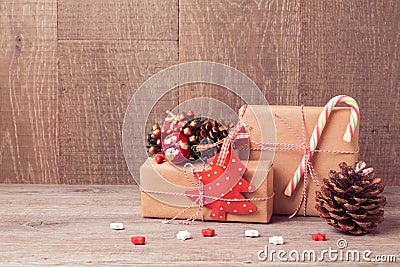 Christmas background with gift boxes and rustic decorations on wooden table Stock Photo