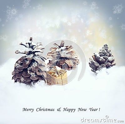 Christmas background with gift, fir tree cone, snowfall. Stock Photo