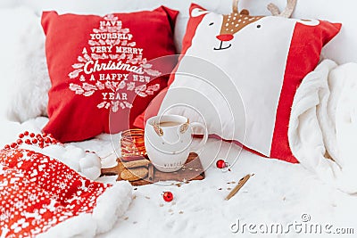 Christmas background. Holiday still life, coffee cup with cookies on bed Stock Photo