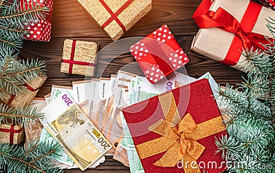Christmas background. Planning the holidays. Gifts for loved ones. Money of different values. Space for text. Top view. Light effe Stock Photo