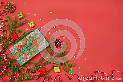 Christmas background - Christmas present green gift box and decoration elements on red background. Creative flat layout and Stock Photo