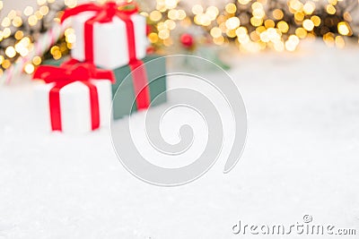 Christmas background with presents, gist boxes with red ribbon, Christmas tree and bokeh of golden lights with copy Stock Photo