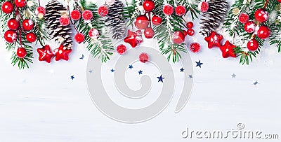 Christmas background with snowy fir branches, cones and red berry. Banner format Stock Photo