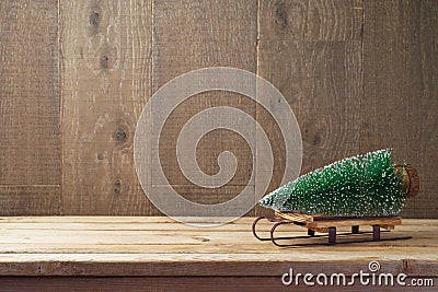 Christmas background with tree on sledges on wooden table Stock Photo