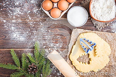 Christmas baking of ginger cookies on dark wooden background with fir branches Stock Photo