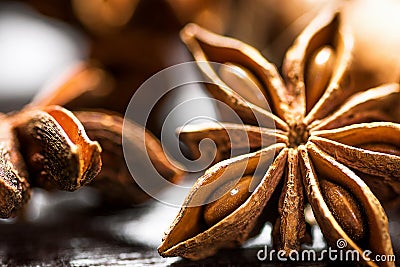 Christmas Baking Ingredients Cinnamon Sticks Anise Star Cloves Cardamom Scattered on Wood Background Macro of Details. Stock Photo