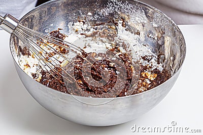 Christmas baking with raw chocolate dough in bowl and whisk. Holiday food concept, homemade child cookies and gingerbread. Close Stock Photo