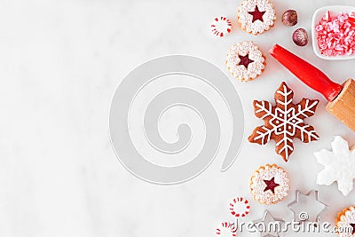 Christmas baking side border with cookies and sweets. Overhead view over a white marble background. Stock Photo