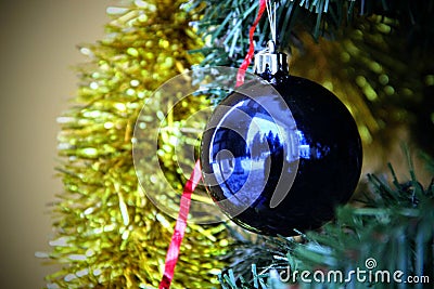 Christmas ball. On a background of golden tinsel blue ball Stock Photo