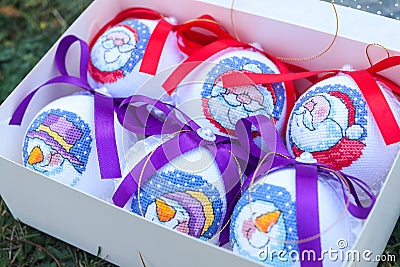 Christmas balls decorated with snowmen and Santa Clauses in a box Stock Photo