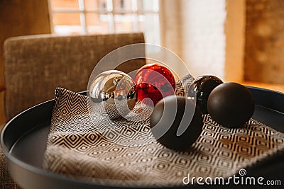 Christmas balls are on a tray against the window Stock Photo