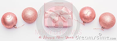 Christmas banner. Beautiful pink christmas gift and ornament baubles isolated on white background. Stock Photo