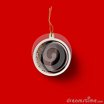 Christmas bauble decoration made of cup of coffee on red background. Minimal concept for Christmas or New Year Stock Photo
