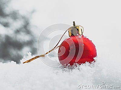 Christmas bauble in the snow, single red bauble Stock Photo