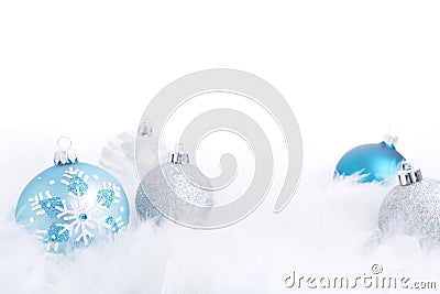 Christmas baubles on a feathery surface, brightly lit Stock Photo