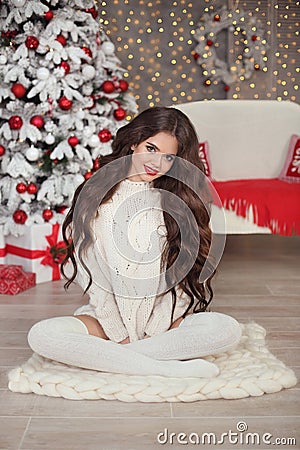 Christmas. Beautiful smiling woman in white knitted sweater and Stock Photo