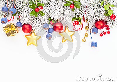 Christmas border composition with holly berries, red baubles, golden garland and green Xmas tree twig isolated on white background Stock Photo