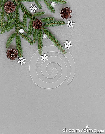 Christmas border with fir branches, cones and silver snowflakes. Vertical orientation. Copy space, top view, flat lay Stock Photo