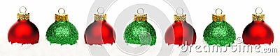 Christmas border of red and green baubles in snow isolated Stock Photo