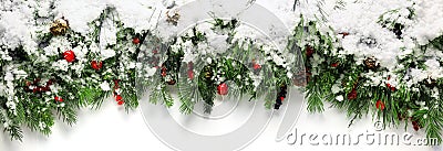 Green Christmas branches with berries covered in snow background Stock Photo