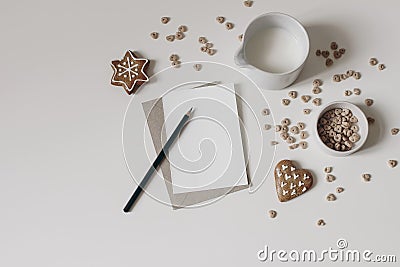 Christmas breakfast still life. Crispy honey oat or buckwheat heart shaped cereals isolated on white table background Stock Photo