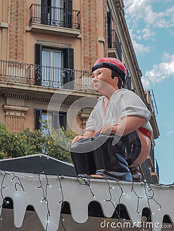 Christmas caganer statue, figurine of pesebre, man pooping Editorial Stock Photo