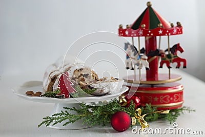 Christmas cake - Stollen, bauble and carousel music box Stock Photo