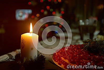 Christmas candle on dark background before the fir-tree. Stock Photo