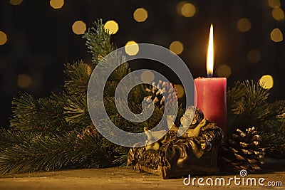Christmas candle with statuette of baby Jesus Stock Photo