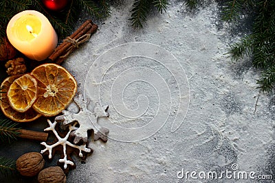 Christmas candle on a white background decorated with fir branches, gingerbread, dried orange slices and cinnamon. Stock Photo