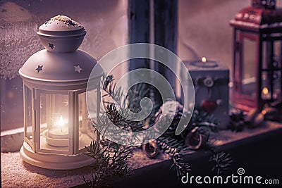 Christmas - candles glow in the steamy window Stock Photo