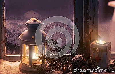 Christmas - candles glow in the steamy window Stock Photo