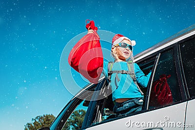Christmas car travel- happy girl with presents enjoy winter vacation Stock Photo