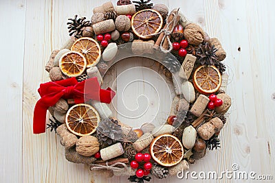 Christmas in a rustic style. Handmade decor. Christmas wreath on the background of old boards. Festive mood. Stock Photo