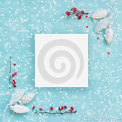 Christmas card or banner; White pine cones and red berries on blue background Stock Photo