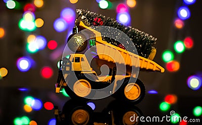 Christmas card. Children`s truck carries a Christmas tree. Bokeh, multicolor color. Merry Christmas concept Stock Photo