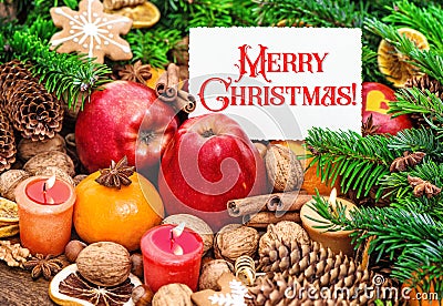 Christmas card concept. Burning candles decoration cookies fruits nuts spices Stock Photo