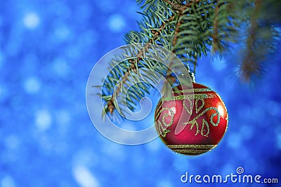 Christmas card. red Christmas ball hanging on your Christmas tree on a blue background Stock Photo