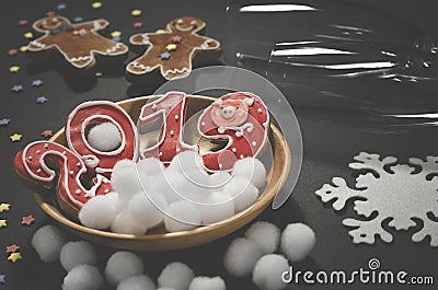 Christmas card: on a wooden plate are red ginger cookies in the shape of numbers 2019 and white round snowflakes Stock Photo