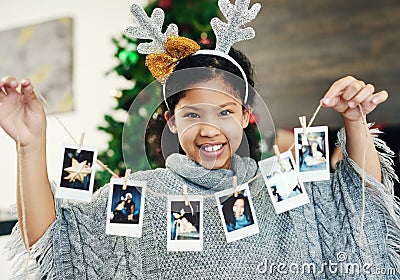 Christmas, celebration and girl with polaroid for decoration, happy and show photos in the house. Smile, excited and Stock Photo