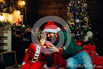 Christmas Celebration holiday. Cute little child boy and daddy near Christmas tree. Merry Christmas and Happy Holidays Stock Photo