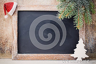 Christmas chalkboard and decoration over wooden background. Stock Photo