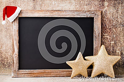 Christmas chalkboard and decoration over wooden background. Stock Photo