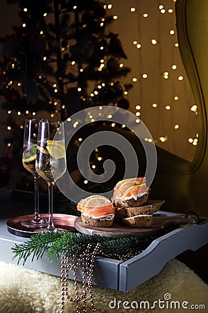 Christmas champagne with red fish appetizer and Christmas tree Stock Photo