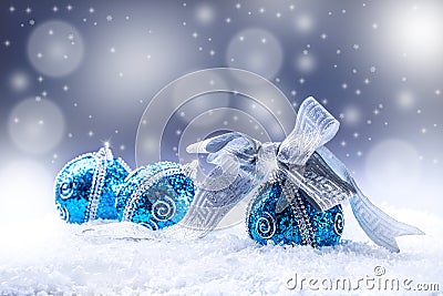 Christmas. Christmas blue balls and silver ribbon snow and space abstract background. Stock Photo