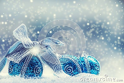 Christmas. Christmas blue balls and silver ribbon snow and space abstract background. Stock Photo