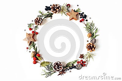 Christmas circle floral composition. Wreath of cypress, eucalyptus branches, pine cones, rowan berries, anise, confetti Stock Photo